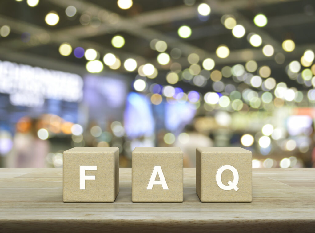 
FAQ letter on wood block cubes on wooden table over blur light and shadow of shopping mall, Frequently asked questions, Business customer service and support concept